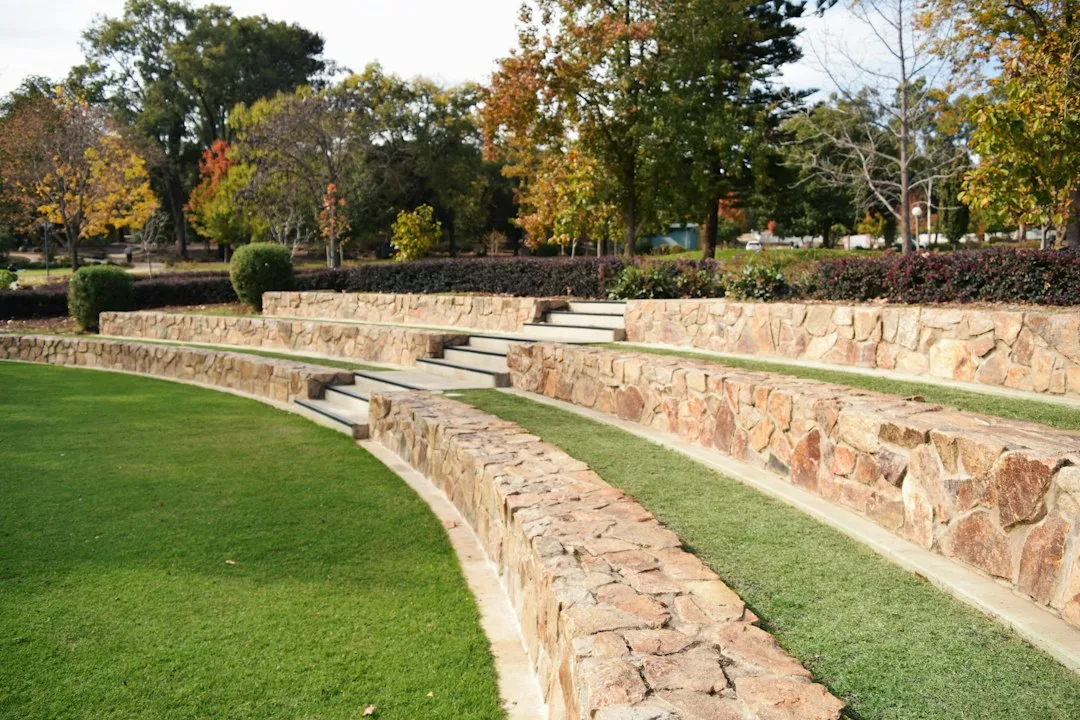 Native plants stabilizing sloped terrain with bioswale stormwater management visible