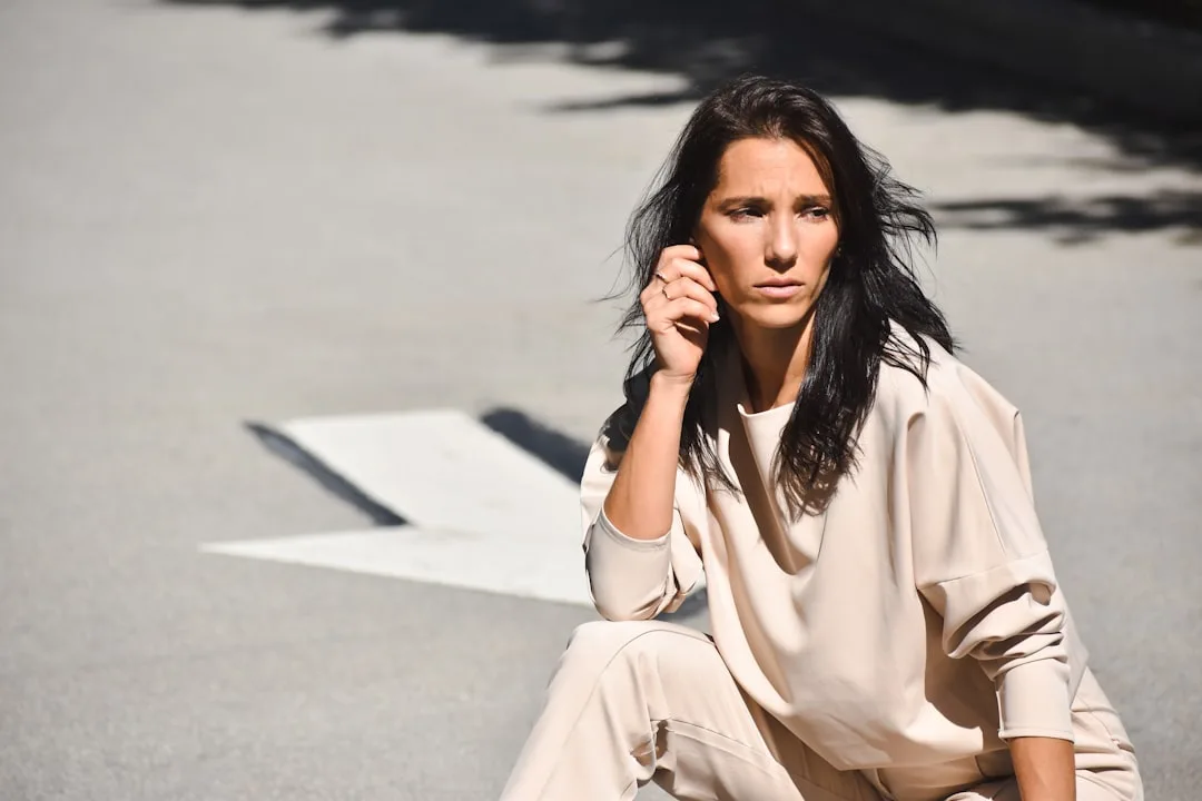 Satin slip dress styled with structured blazer and minimal accessories