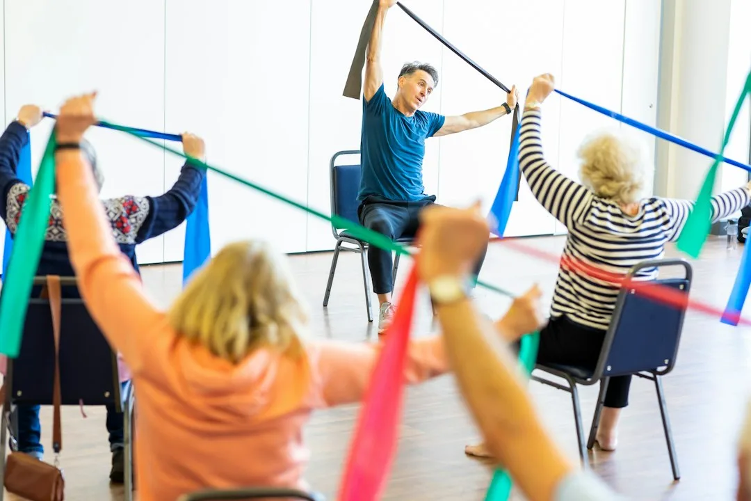 Mature adult performing low-impact strength training with resistance band