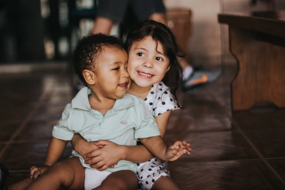 Two siblings collaborating on activity with clear individual roles assigned