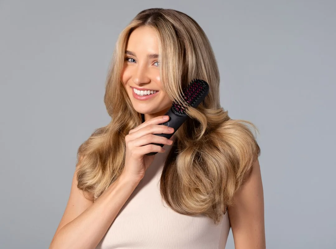 Woman with sleek long hair styled in smooth polished texture fall 2026