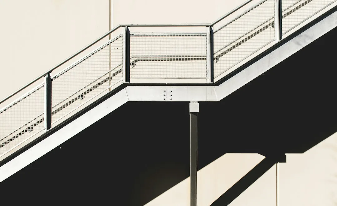 Metal and composite stair nosing installation protecting wooden stair edges