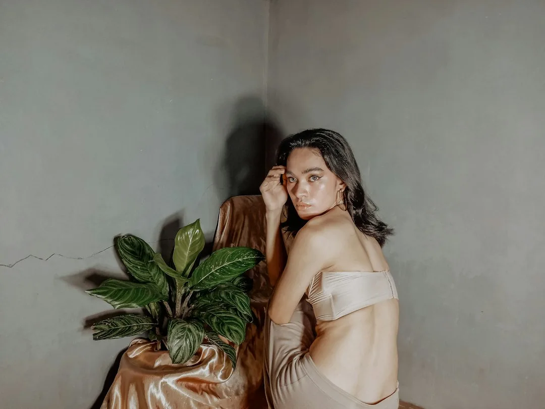 Woman wearing champagne satin slip dress layered with oversized linen shirt