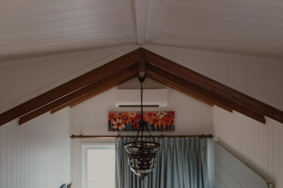 Reclaimed barn beam installation detail showing notch joinery and warm patina