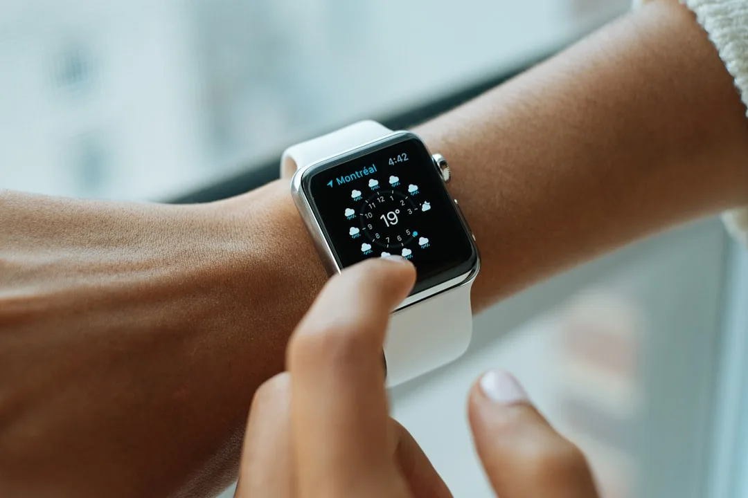 Woman checking predictive health monitoring wearables data on smartwatch display