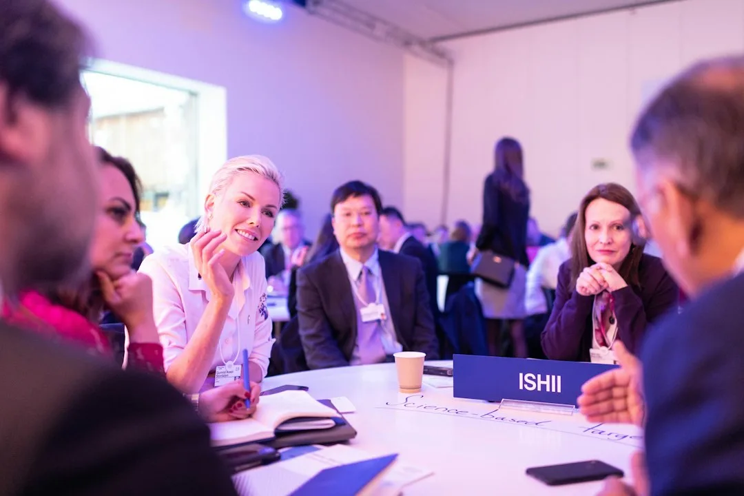 group of attendees collaborating at interactive networking workshop station