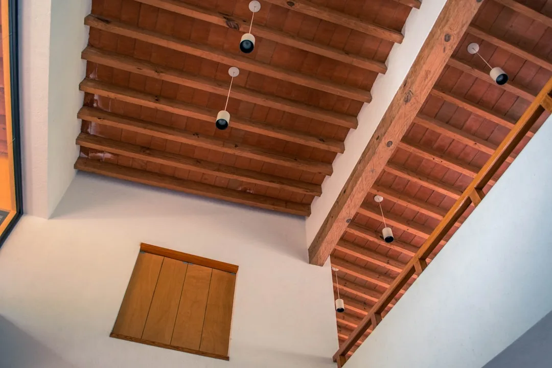 Hand-finished Douglas fir ceiling beams spanning open-plan kitchen and dining room
