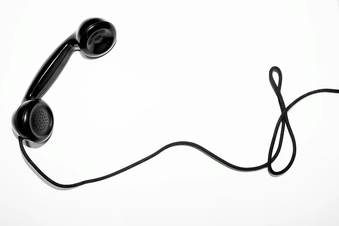 Close view of a learner wearing headphones while speaking into a smartphone lesson screen