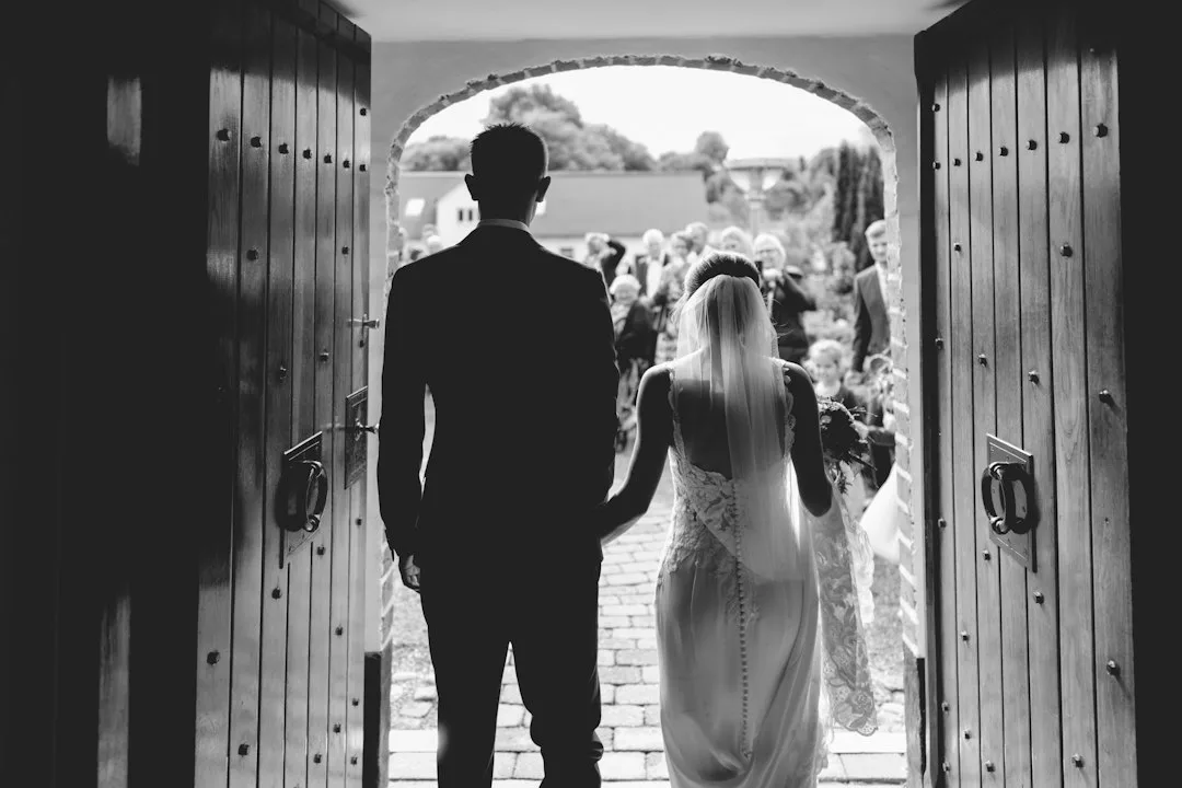Groom and bride standing at altar as wedding processional music plays