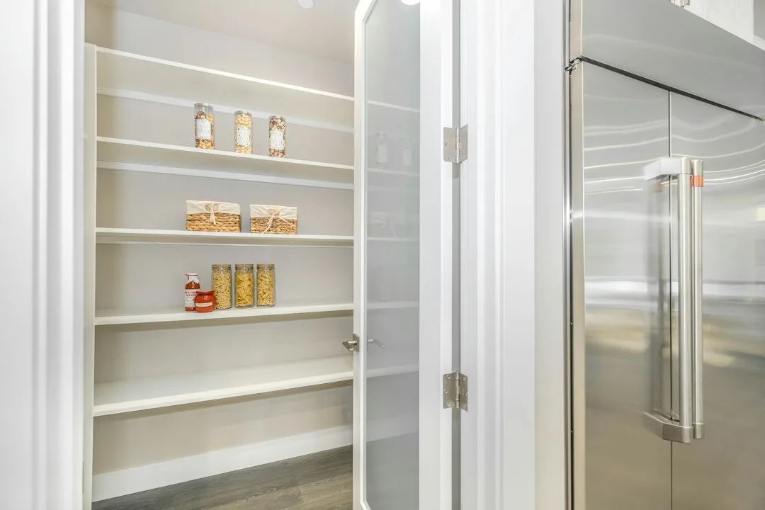 Magnetic pantry door catch system preventing accidental opening