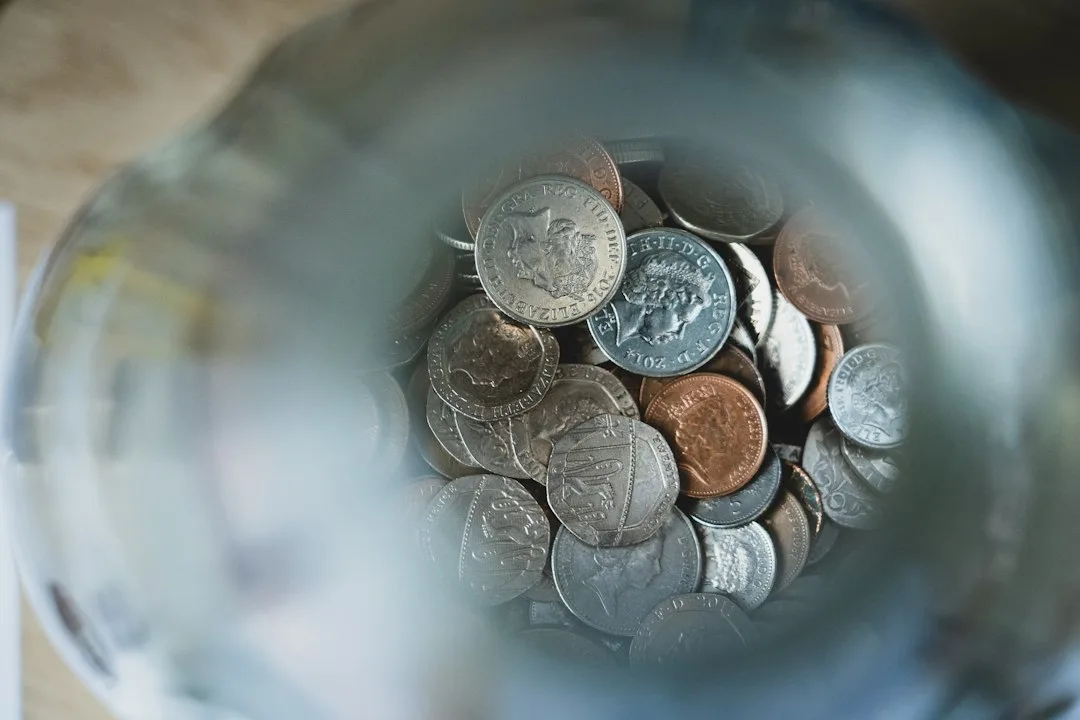Child sorting coins into jars in an allowance system for kids