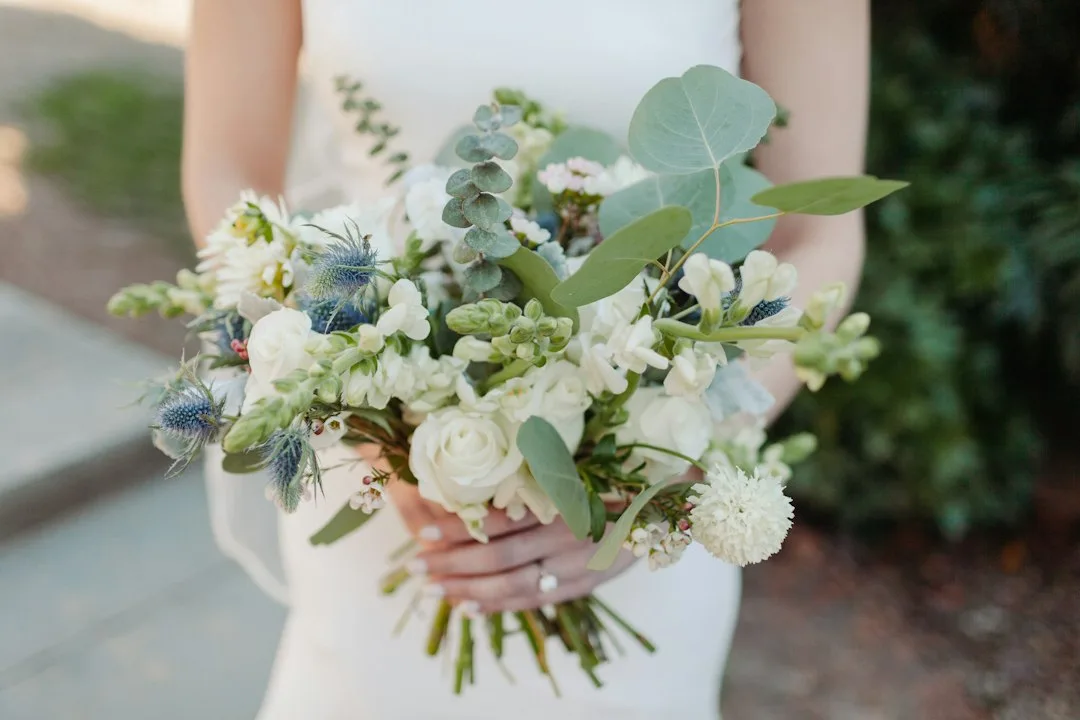 Loose garden wedding bouquet trends with mixed seasonal stems and trailing greenery