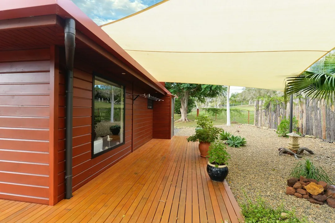 Shade sail installation stretched across residential backyard with multiple anchor points