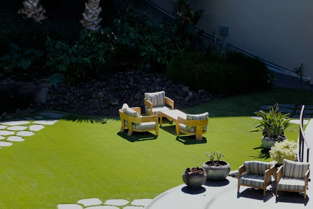 Woven flatweave outdoor rug under a patio conversation set with wicker chairs