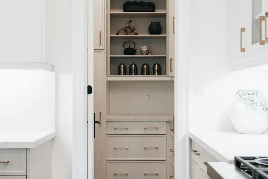Brushed nickel pantry door pull handle on white shaker door