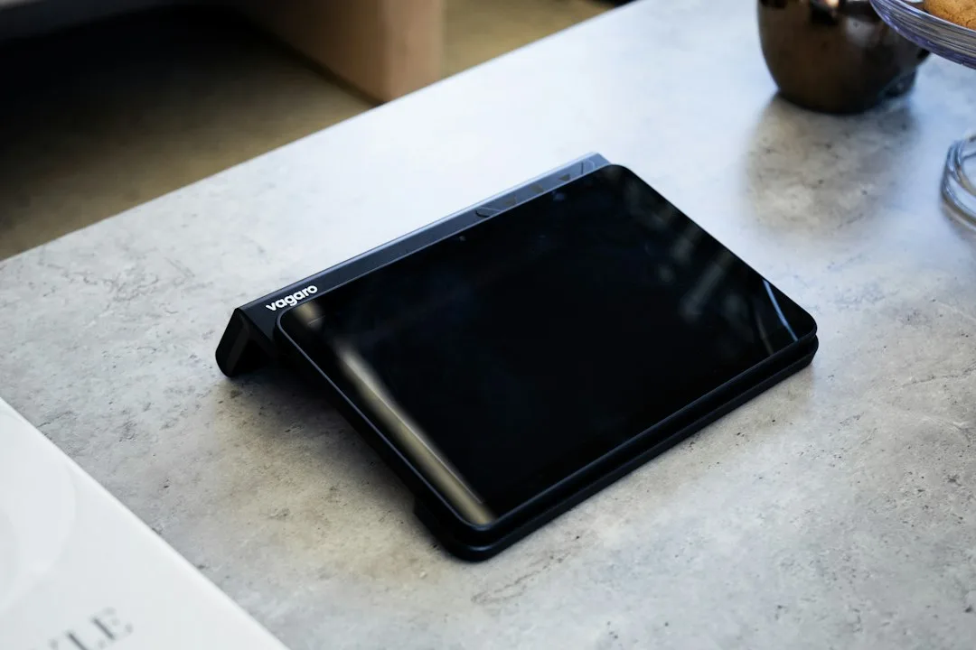 Foldable phones opened to a tablet-size screen on a wooden desk