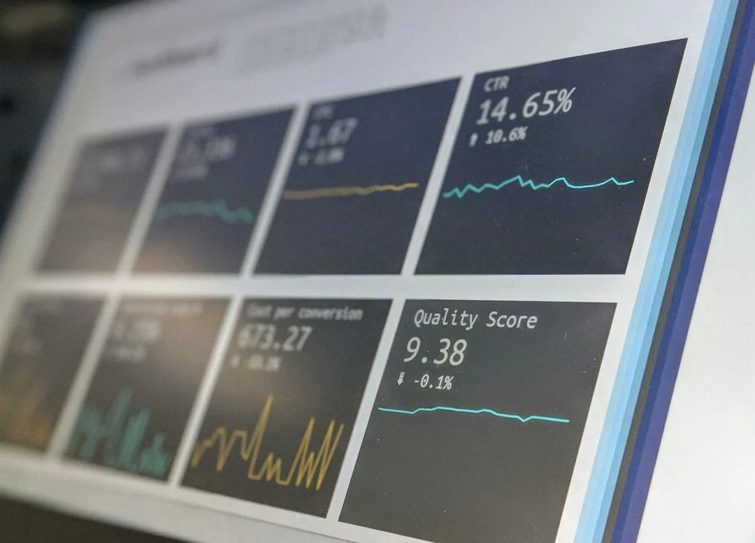 Employee comparing course completion charts with on-the-job skill scores on a laptop screen