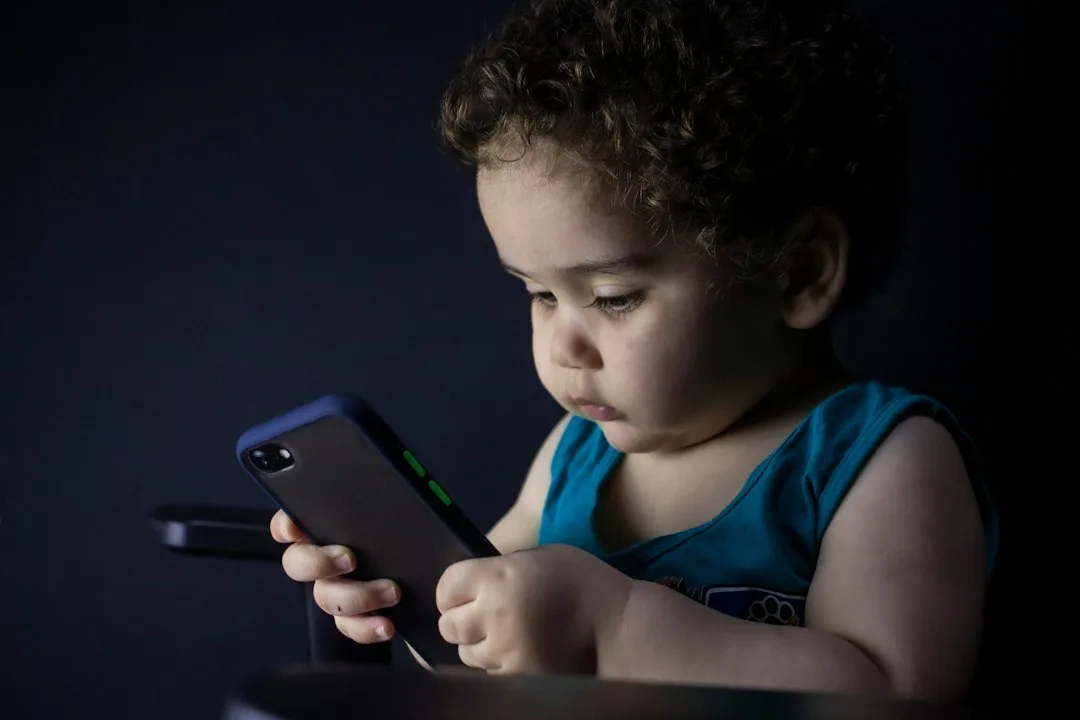 Teen reviewing privacy settings on phone while parent watches supportively