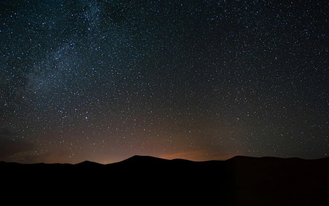 Dark sky travel view of Milky Way above desert campsite